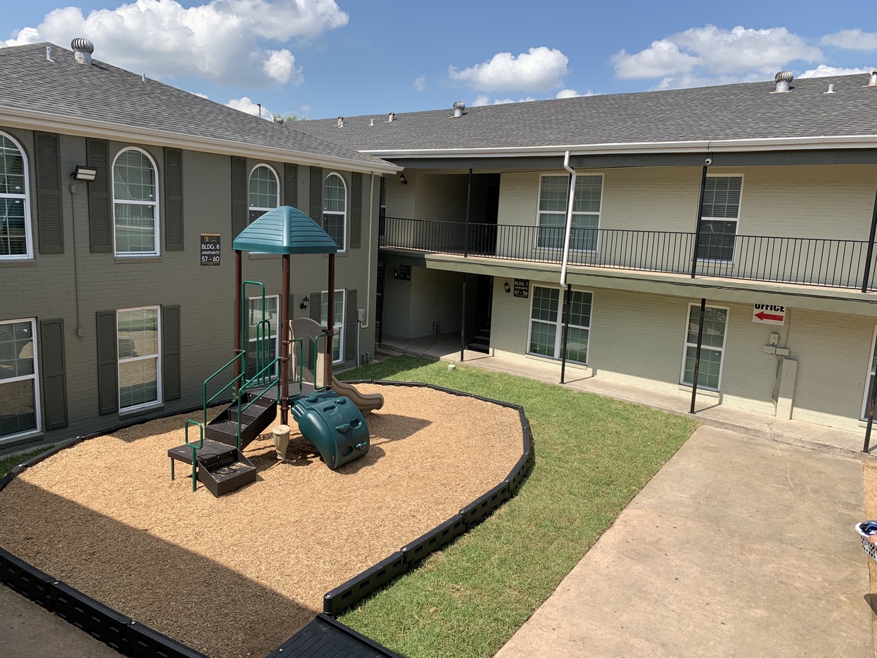 Courtyard playground between Carvel Apartments buildings